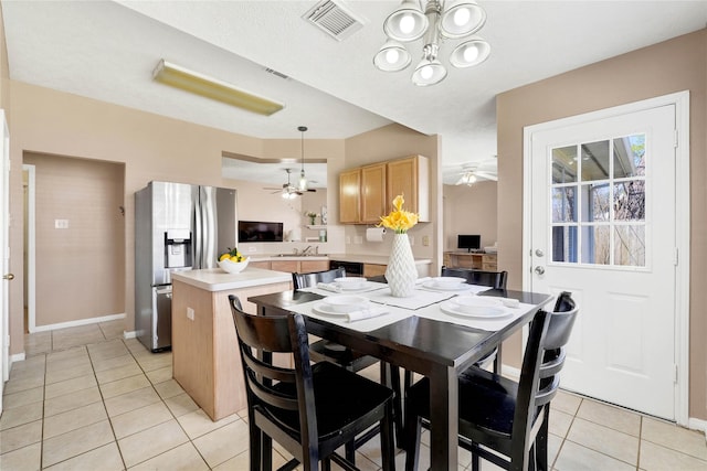 dining room with baseboards, visible vents, a ceiling fan, and light tile patterned flooring