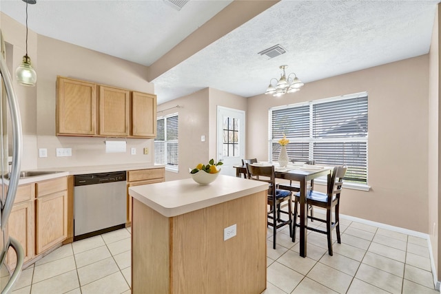 kitchen with light tile patterned floors, light brown cabinets, visible vents, and dishwasher