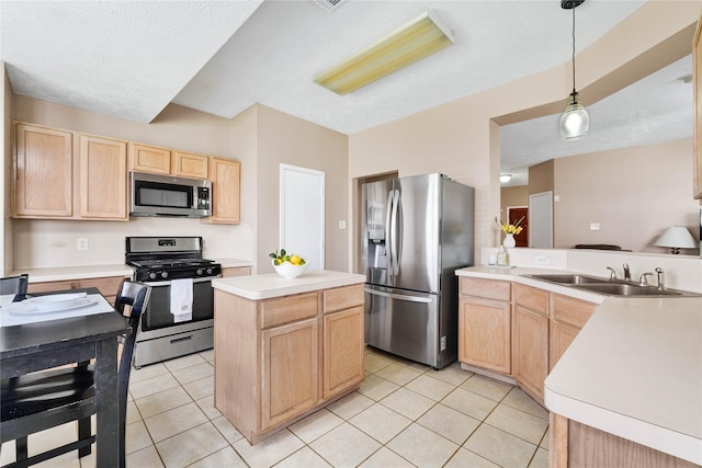 kitchen with light brown cabinetry, appliances with stainless steel finishes, light tile patterned flooring, and a sink