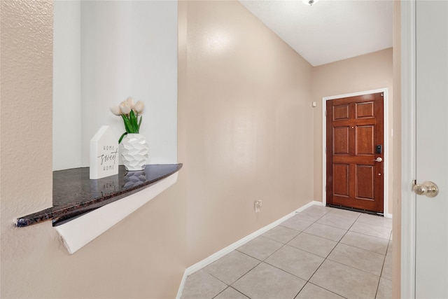 entrance foyer with light tile patterned flooring and baseboards