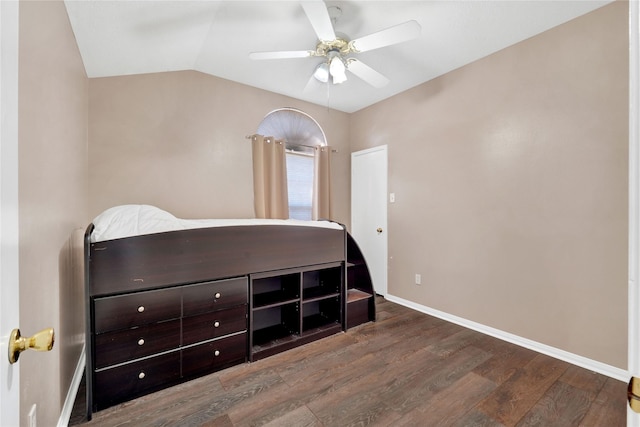 bedroom with ceiling fan, baseboards, vaulted ceiling, and wood finished floors