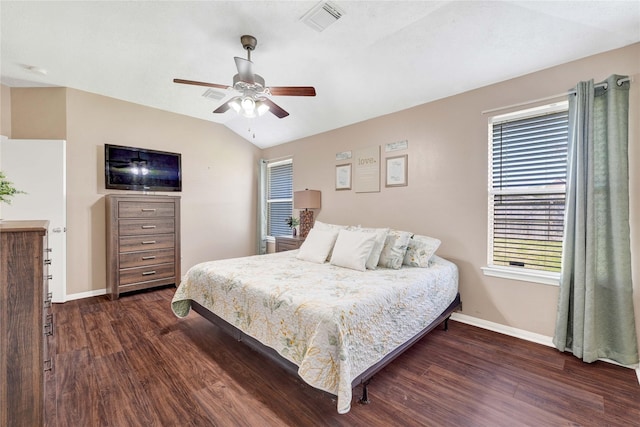 bedroom with lofted ceiling, dark wood finished floors, visible vents, and baseboards