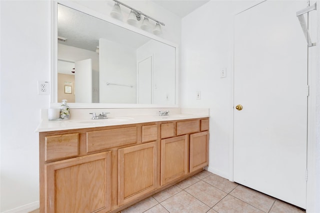 full bathroom featuring tile patterned flooring, a sink, and double vanity