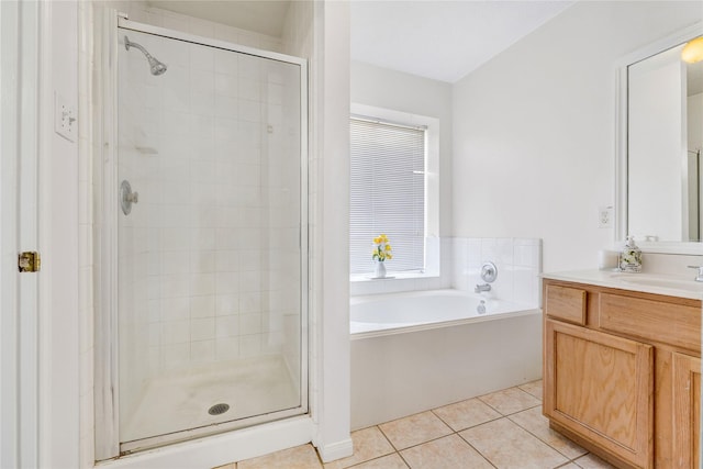 bathroom featuring a garden tub, a shower stall, vanity, and tile patterned floors