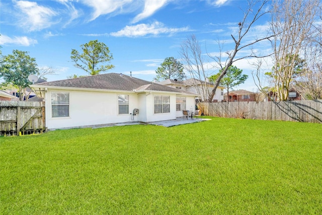 back of property featuring a patio area, a fenced backyard, a yard, and stucco siding