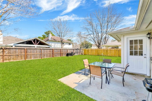 view of yard with a patio, outdoor dining area, and a fenced backyard