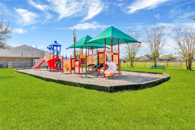 community playground with fence and a lawn