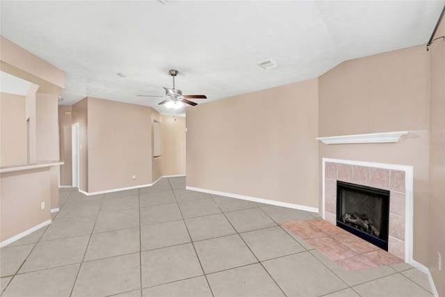 unfurnished living room featuring a fireplace, baseboards, a ceiling fan, and tile patterned floors