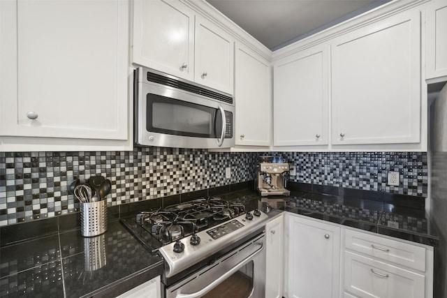 kitchen with dark countertops, white cabinets, and stainless steel appliances