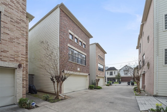 exterior space featuring concrete driveway and an attached garage