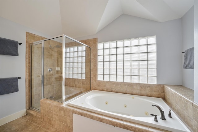 bathroom featuring tile patterned flooring, a tub with jets, a shower stall, and vaulted ceiling