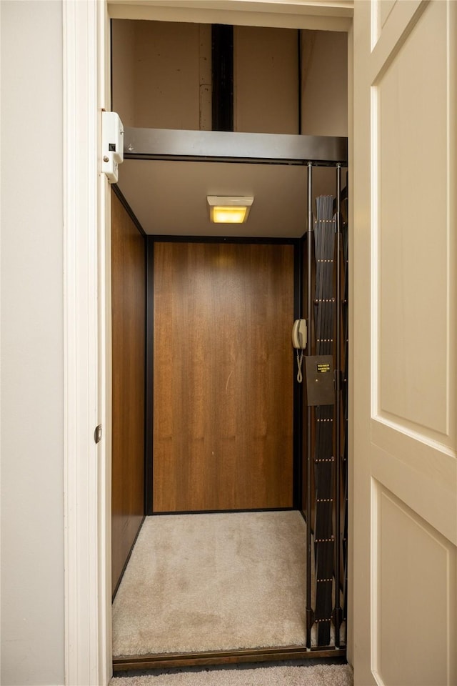 room details featuring elevator and carpet flooring