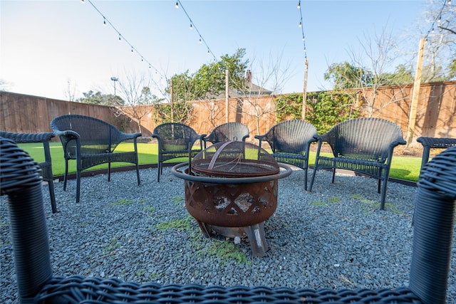 exterior space featuring an outdoor fire pit, a patio area, and a fenced backyard