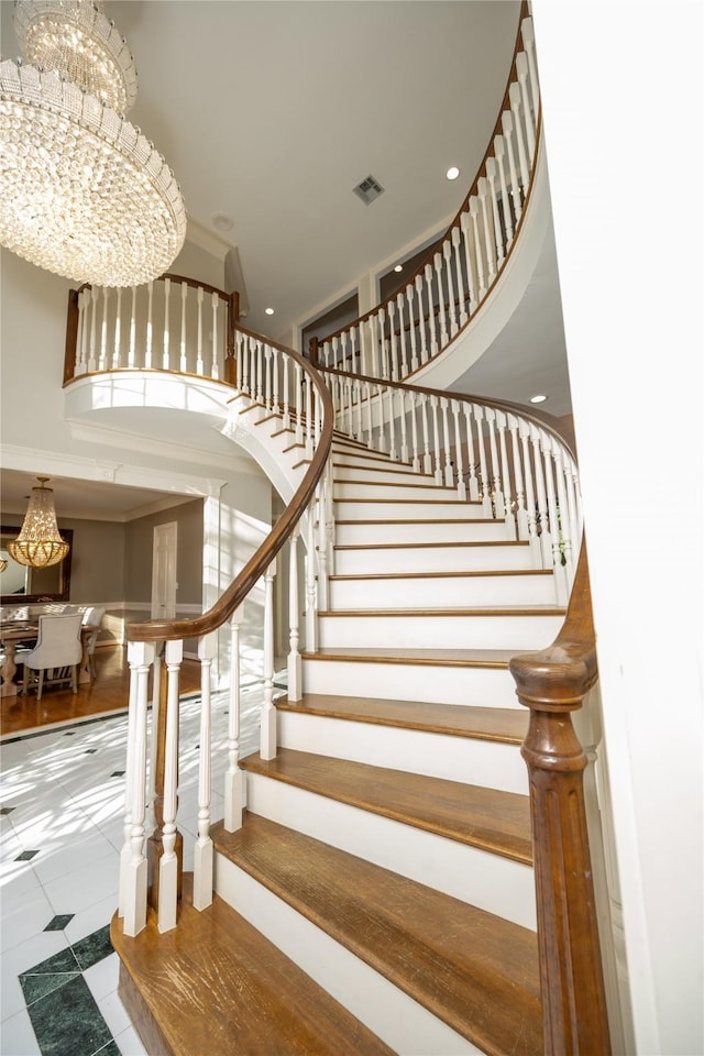 stairs featuring a high ceiling, visible vents, a chandelier, and recessed lighting