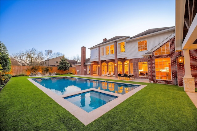 view of pool featuring a fenced in pool, a yard, a patio area, an in ground hot tub, and a fenced backyard