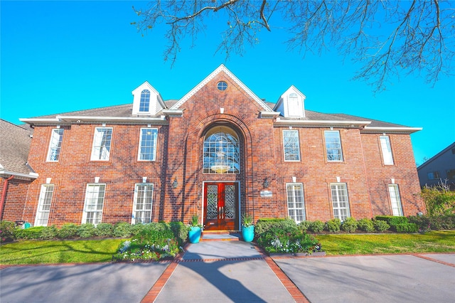 view of front of house with french doors and brick siding