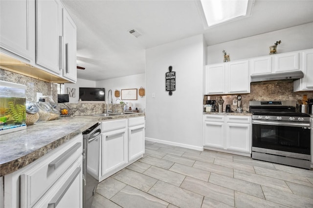 kitchen with tasteful backsplash, under cabinet range hood, appliances with stainless steel finishes, white cabinetry, and a sink