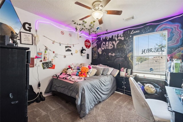 bedroom featuring visible vents, ceiling fan, a textured ceiling, and carpet