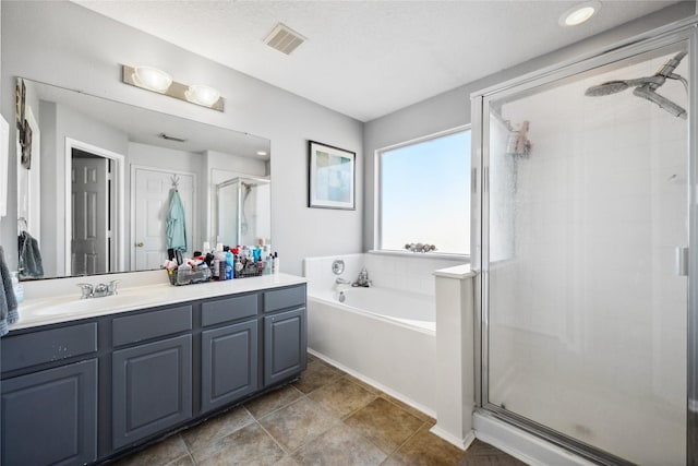 full bath featuring vanity, a garden tub, visible vents, and a stall shower