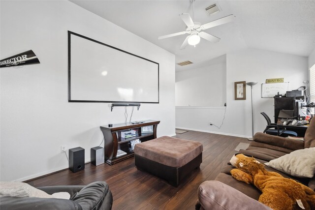 home theater room featuring visible vents, lofted ceiling, a ceiling fan, and hardwood / wood-style flooring