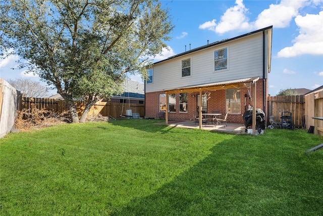 back of house featuring a patio area, a fenced backyard, brick siding, and a lawn