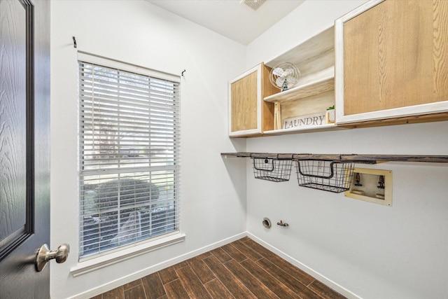 laundry area featuring dark wood-style floors, washer hookup, cabinet space, gas dryer hookup, and baseboards