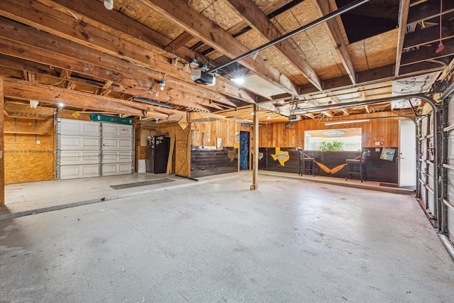 garage featuring a garage door opener and water heater