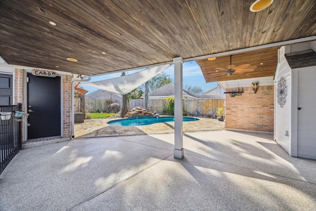 view of patio featuring a fenced in pool, a fenced backyard, and a ceiling fan