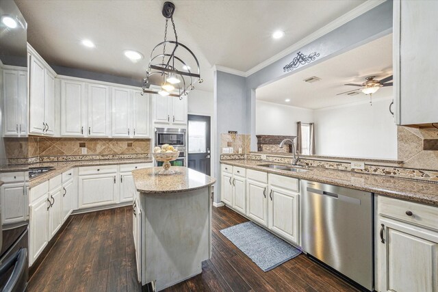 kitchen featuring stainless steel appliances, dark wood-style flooring, white cabinets, and a sink