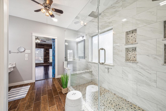 full bath with baseboards, a shower stall, and wood tiled floor