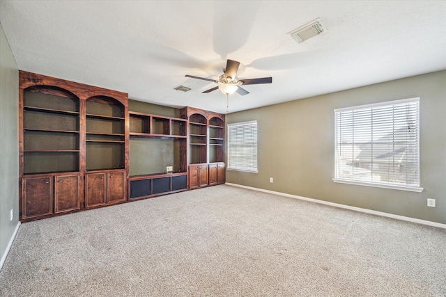 interior space with a healthy amount of sunlight, baseboards, and visible vents