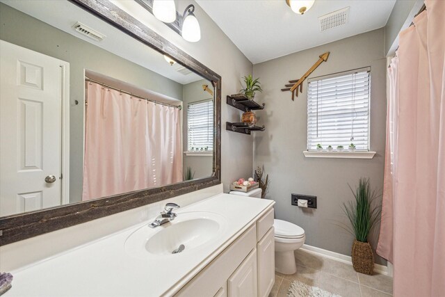 full bathroom with tile patterned flooring, visible vents, vanity, and toilet