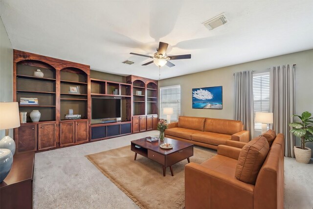 living area featuring a ceiling fan, carpet, and visible vents