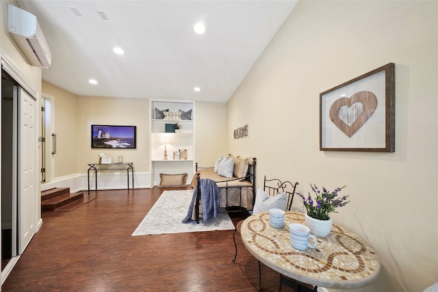 sitting room featuring a wall unit AC, recessed lighting, dark wood-type flooring, and baseboards