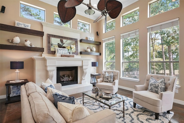 living room with crown molding, plenty of natural light, and baseboards