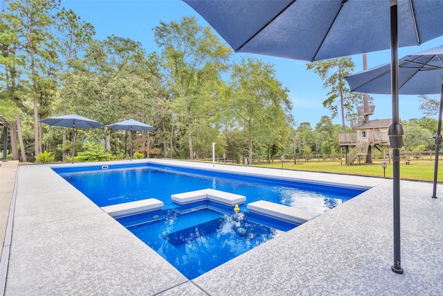 view of pool featuring a patio area, a playground, a lawn, and a pool with connected hot tub