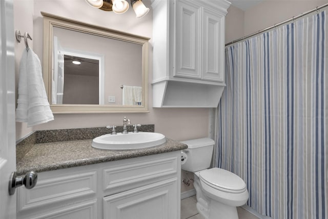 bathroom featuring tile patterned floors, toilet, and vanity