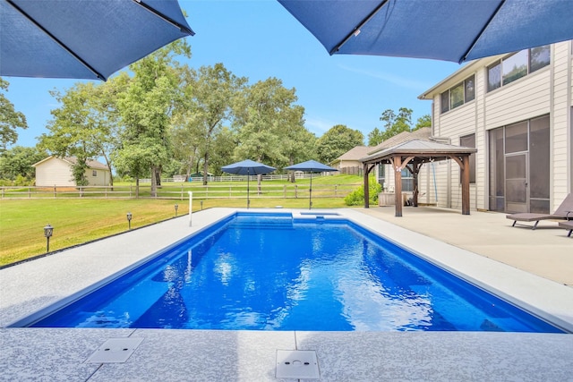 view of pool featuring a patio, fence, a fenced in pool, a gazebo, and a lawn