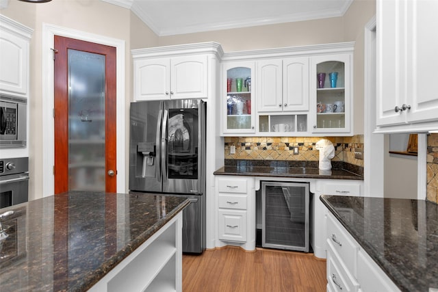 kitchen featuring crown molding, wine cooler, light wood-type flooring, white cabinets, and stainless steel appliances