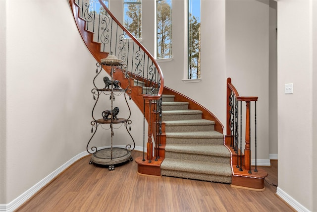 stairs featuring baseboards and wood finished floors