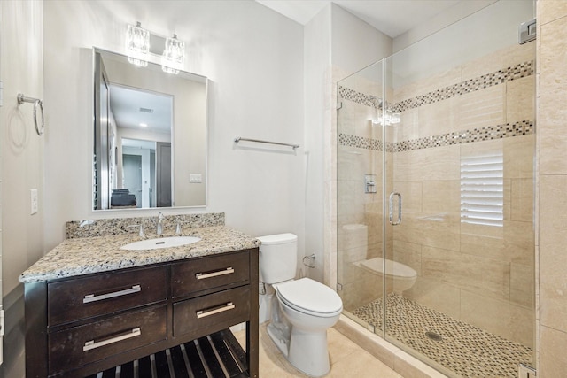 bathroom with tile patterned flooring, a shower stall, toilet, and vanity