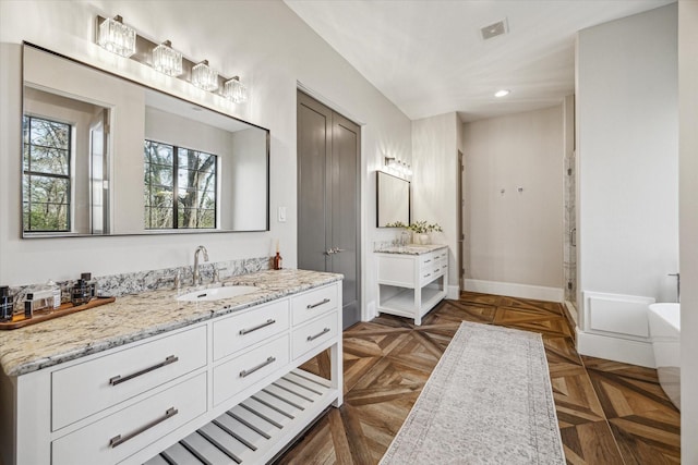 full bathroom featuring recessed lighting, vanity, visible vents, baseboards, and a stall shower