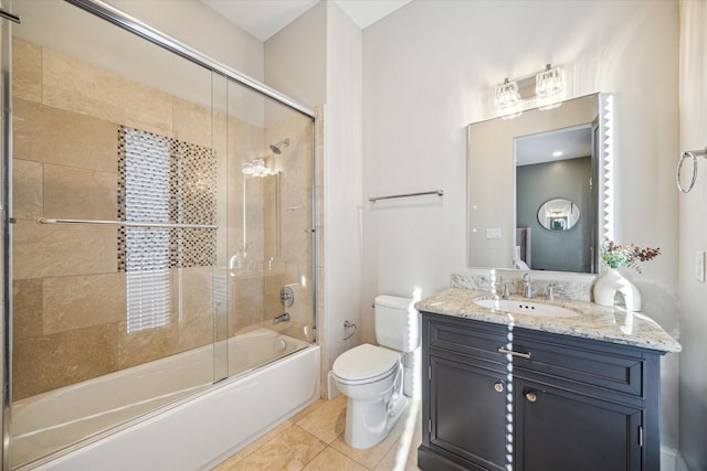 bathroom featuring toilet, shower / bath combination with glass door, tile patterned flooring, and vanity