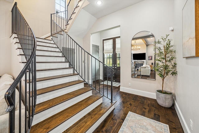 foyer entrance featuring arched walkways, recessed lighting, wood-type flooring, baseboards, and stairs