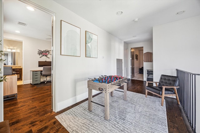 rec room featuring dark wood-style flooring, recessed lighting, visible vents, and baseboards