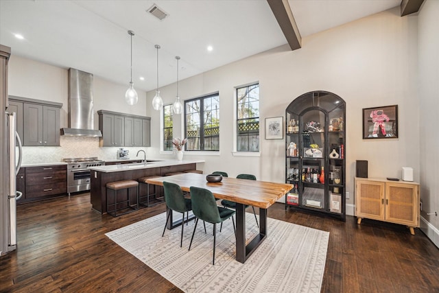 dining area with recessed lighting, dark wood-style flooring, visible vents, and beamed ceiling