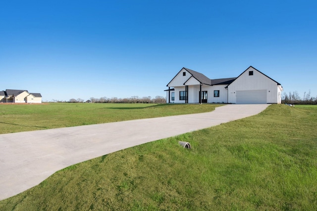 modern inspired farmhouse with an attached garage, board and batten siding, a front lawn, and concrete driveway