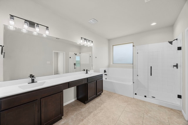 bathroom featuring double vanity, a garden tub, tile patterned flooring, a shower stall, and a sink