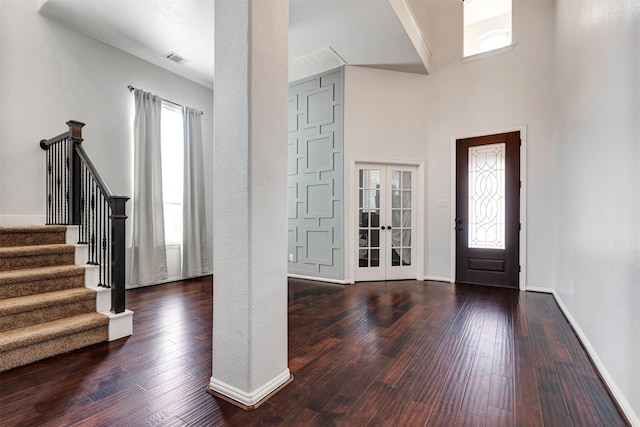 foyer entrance with stairway, visible vents, french doors, and hardwood / wood-style flooring