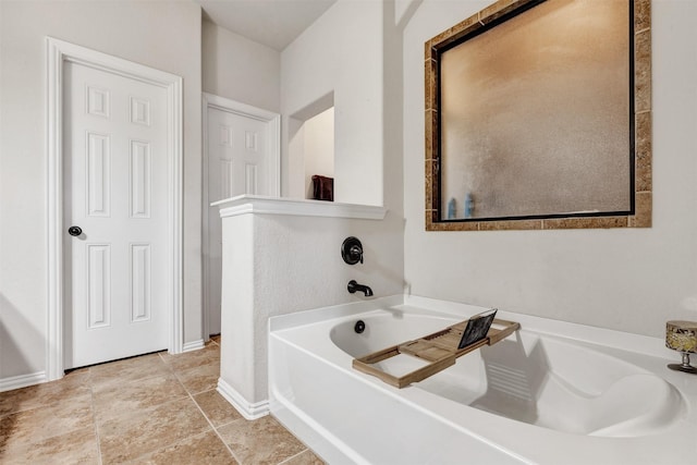 bathroom with baseboards and a garden tub